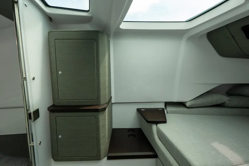 Slide: The Image of 2024 Axopar 37 Cross Cabin XC interior with storage cabinets and seating area. - 20
