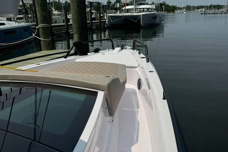 Slide: The Image of 2024 Axopar 37 Cross Cabin XC docked at a marina, showcasing sleek design and spacious deck. - 6