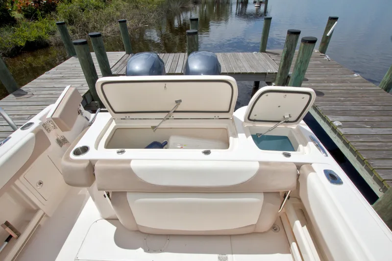 Slide: The Image of 2013 Grady-White Freedom 275 boat with open storage compartments at dockside. - 14