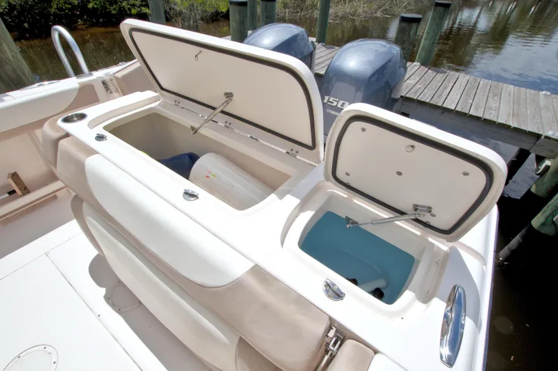 Slide: The Image of 2013 Grady-White Freedom 275 boat with open storage compartments and twin Yamaha engines. - 15