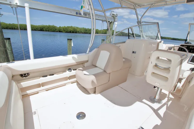 Slide: The Image of 2013 Grady-White Freedom 275 boat interior with seating, helm, and water view. - 18