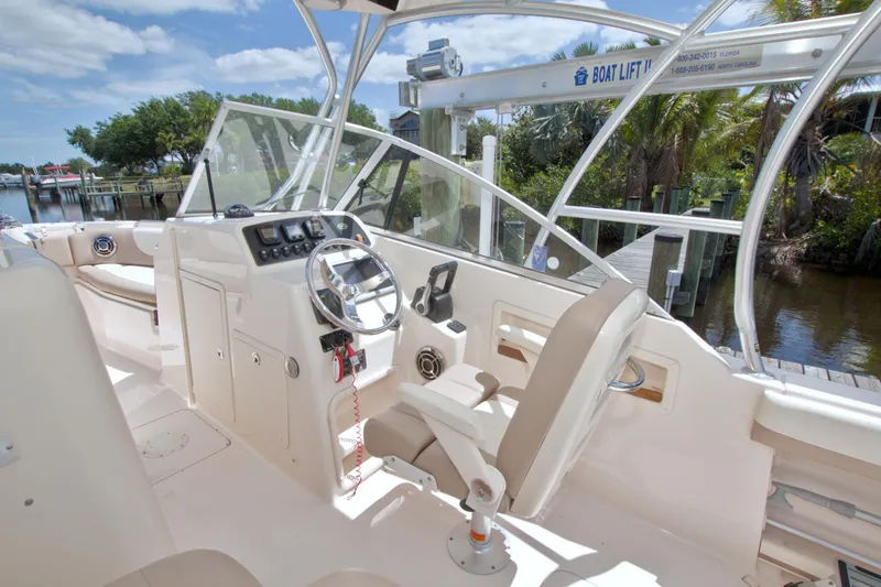 Slide: The Image of 2013 Grady-White Freedom 275 boat interior with steering wheel and seating. - 22