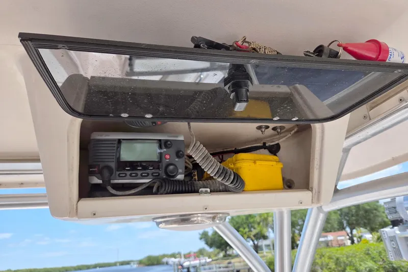 Slide: The Image of 2013 Grady-White Freedom 275 boat console with radio and safety equipment. - 23