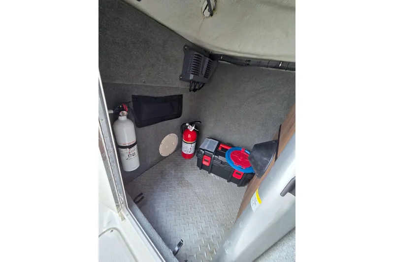 Slide: The Image of Interior storage of 2013 Grady-White Freedom 275 boat with safety equipment and tools. - 27