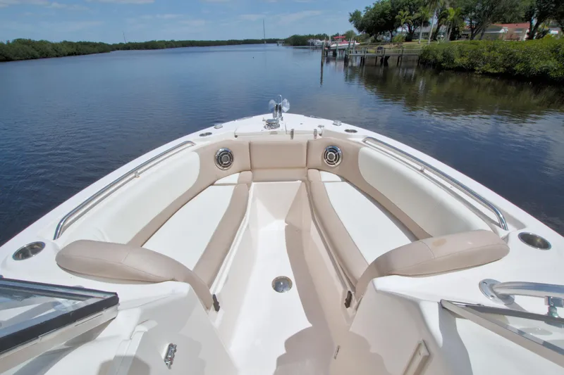 Slide: The Image of 2013 Grady-White Freedom 275 boat interior with spacious seating on calm water. - 28