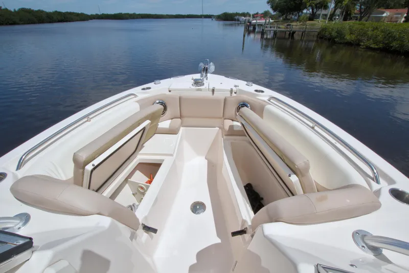 Slide: The Image of 2013 Grady-White Freedom 275 boat interior with spacious seating on a calm river. - 29