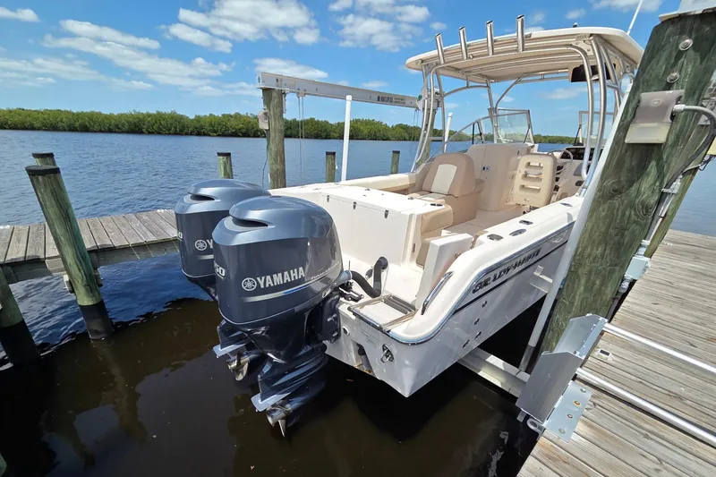 Slide: The Image of 2013 Grady-White Freedom 275 boat docked with twin Yamaha engines. - 3