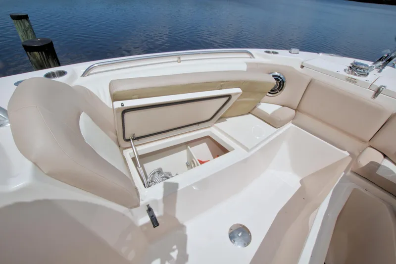Slide: The Image of 2013 Grady-White Freedom 275 boat interior with open storage compartment by the water. - 31