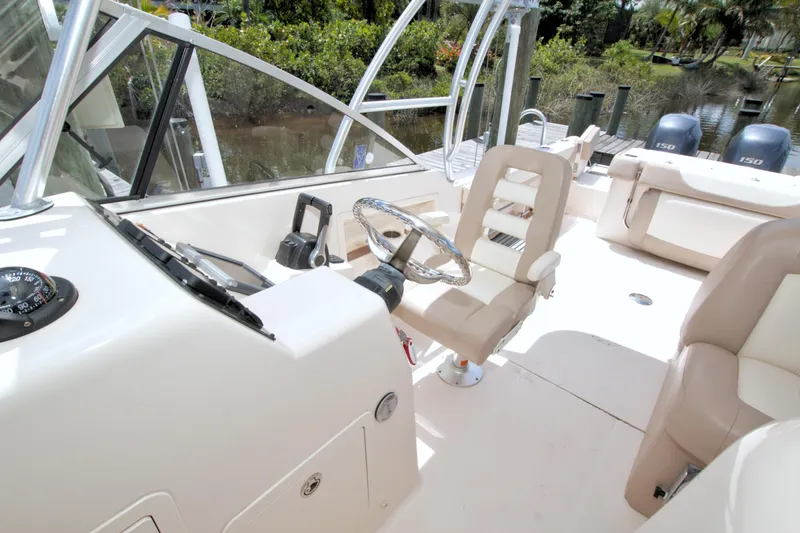 Slide: The Image of 2013 Grady-White Freedom 275 boat interior with steering wheel and seating. - 34
