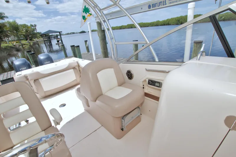Slide: The Image of 2013 Grady-White Freedom 275 boat interior with seating and scenic waterfront view. - 35