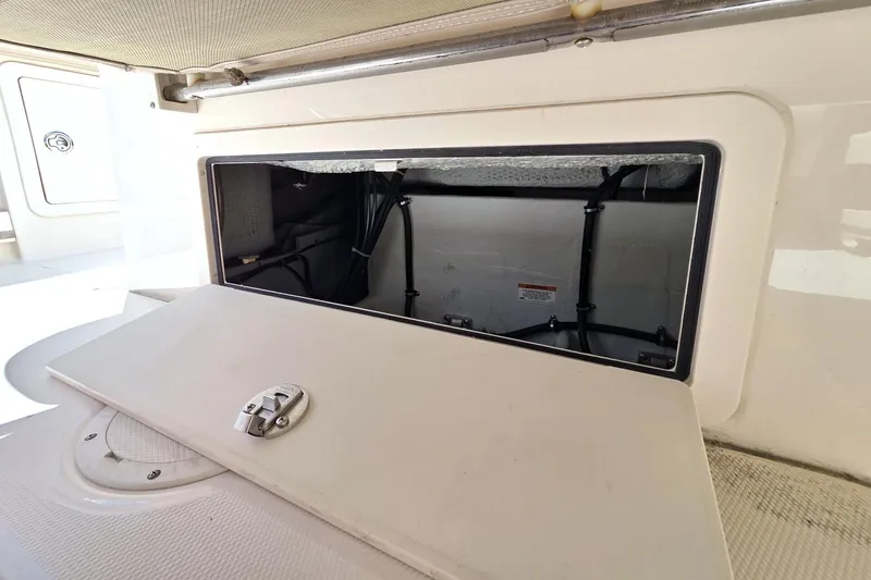Slide: The Image of Storage compartment on a 2013 Grady-White Freedom 275 boat, open with visible interior. - 37