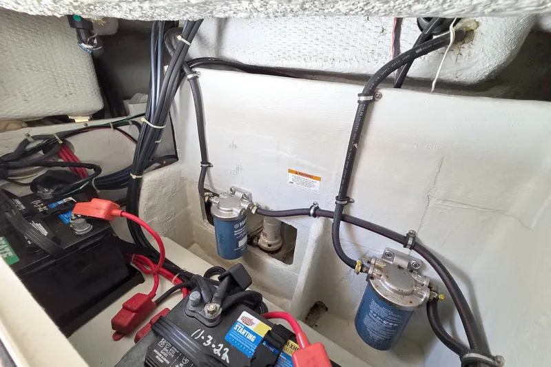 Slide: The Image of 2013 Grady-White Freedom 275 boat engine compartment with batteries and fuel filters. - 38