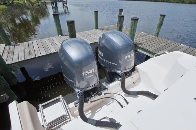 Slide: The Image of Twin Yamaha 150 outboard engines on a 2013 Grady-White Freedom 275 boat at dock. - 39