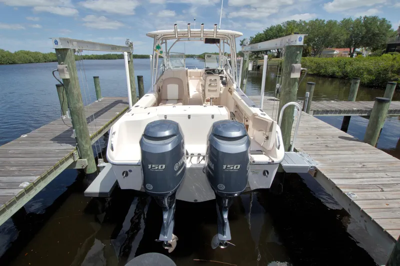 Slide: The Image of 2013 Grady-White Freedom 275 boat docked with twin Yamaha 150 engines. - 4