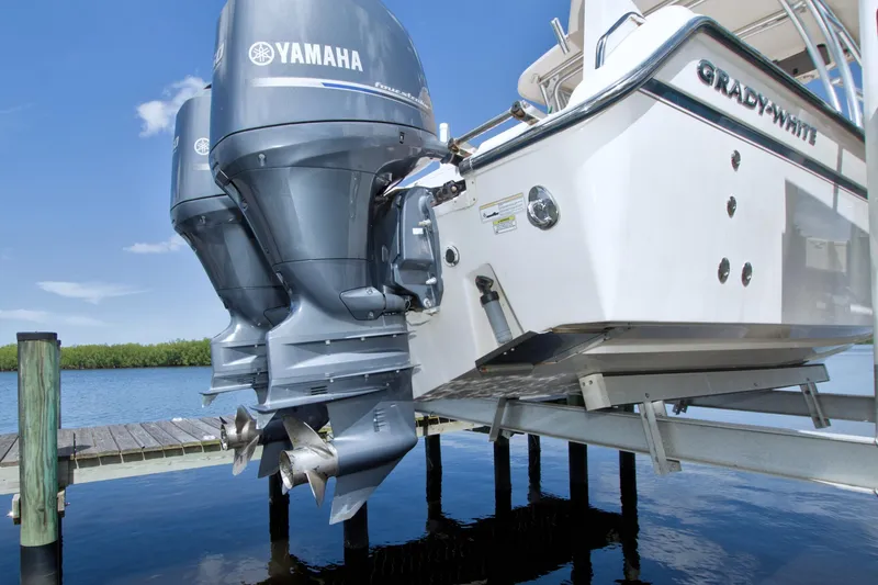 Slide: The Image of 2013 Grady-White Freedom 275 boat with Yamaha outboard engines on a lift. - 42