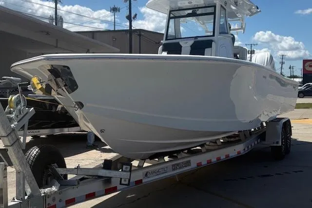 The Image of 2026 Tidewater 3100 Carolina Bay boat on trailer, parked outdoors under a clear sky. - 0