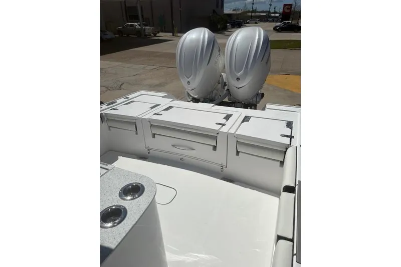 Slide: The Image of 2026 Tidewater 3100 Carolina Bay boat with dual engines and spacious deck layout. - 3