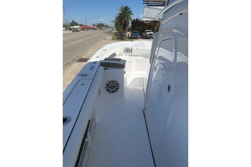 Slide: The Image of 2026 Tidewater 3100 Carolina Bay boat, sleek white deck, roadside view. - 6