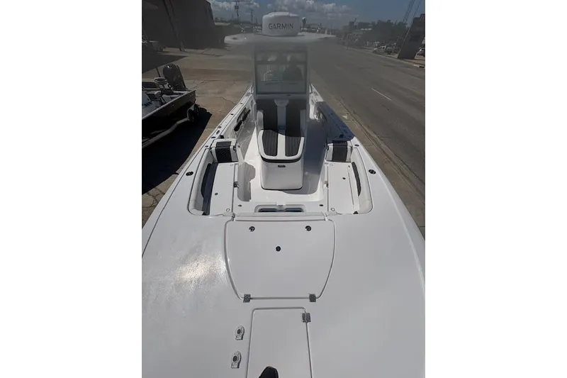 Slide: The Image of 2026 Tidewater 3100 Carolina Bay boat with sleek white deck and Garmin navigation. - 7