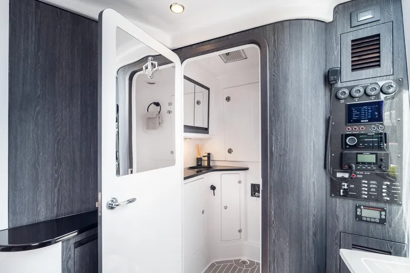 Slide: The Image of Interior of 2025 Cigarette 42' Auroris boat, featuring modern control panel and sleek cabinetry. - 11