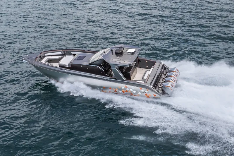 Slide: The Image of 2025 Cigarette 42' Auroris speedboat cruising on open water, showcasing sleek design and powerful engines. - 4