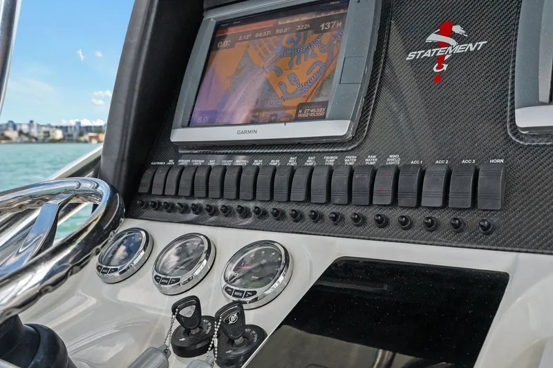 Slide: The Image of Dashboard of Statement 350 Open boat, 2012 model, featuring Garmin navigation system. - 32