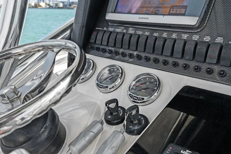 Slide: The Image of Dashboard of a 2012 Statement 350 Open boat with Garmin navigation. - 33