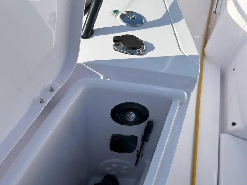 Slide: The Image of 2024 Axopar Cross Cabin storage compartment with utility features and sleek design. - 20