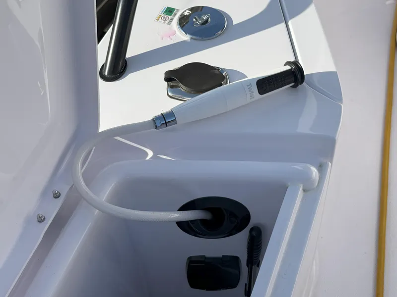 Slide: The Image of 2024 Axopar Cross Cabin boat detail with hose and control panel. - 21
