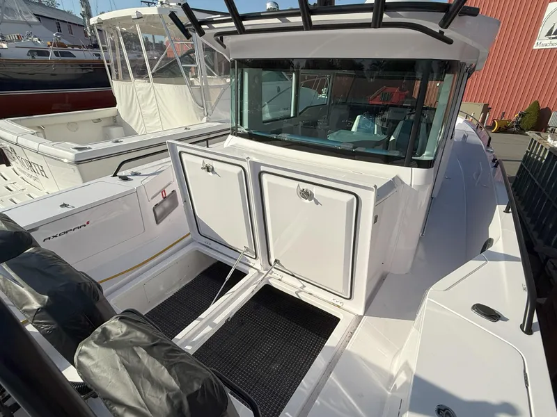 Slide: The Image of 2024 Axopar Cross Cabin boat with sleek design and spacious deck area. - 25