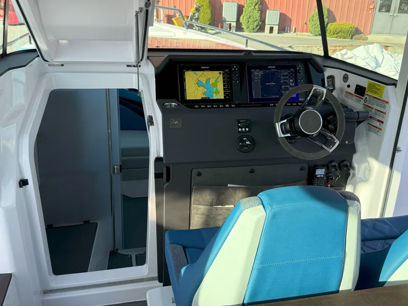 Slide: The Image of 2024 Axopar Cross Cabin interior with navigation system and blue seating. - 31