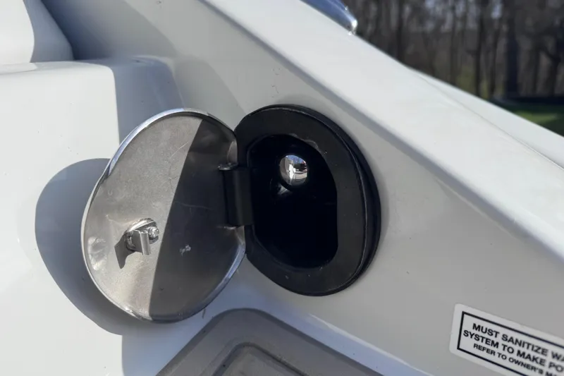 Slide: The Image of Fuel cap of 2022 Crownline 265 SS boat, open with safety instructions visible. - 12