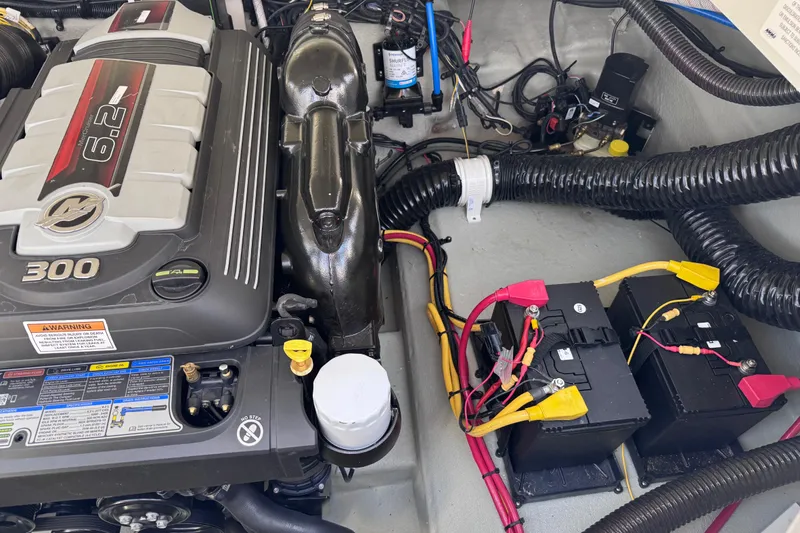 Slide: The Image of Engine compartment of 2022 Crownline 265 SS boat, featuring a 6.2L engine and dual batteries. - 17