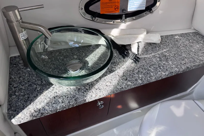 Slide: The Image of Modern glass sink and faucet on granite countertop in 2022 Crownline 265 SS boat. - 24