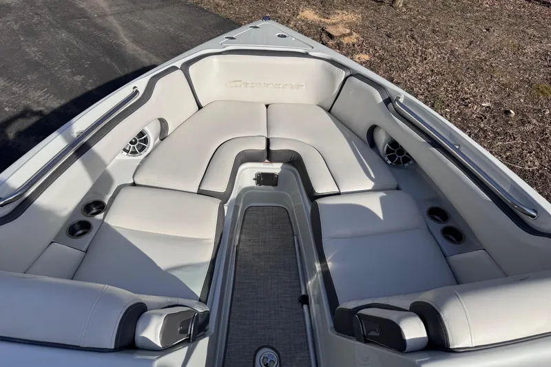 Slide: The Image of 2022 Crownline 265 SS boat interior with plush seating and cup holders. - 27