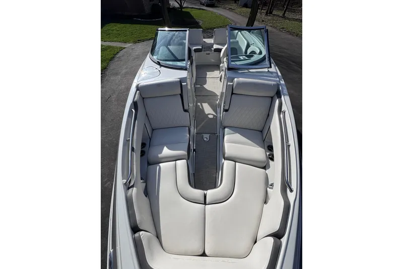 Slide: The Image of 2022 Crownline 265 SS boat interior with white seating and open windshield. - 30