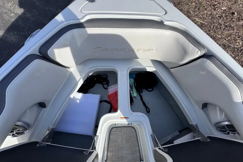 Slide: The Image of 2022 Crownline 265 SS boat interior with storage compartments and seating. - 31