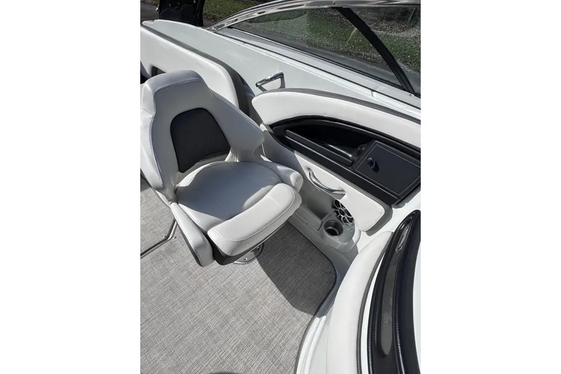 Slide: The Image of 2022 Crownline 265 SS boat interior with white seating and sleek dashboard design. - 36