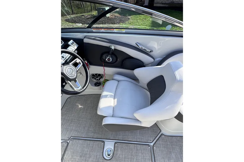 Slide: The Image of 2022 Crownline 265 SS boat interior with steering wheel and captain's seat. - 38