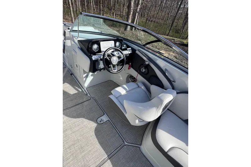 Slide: The Image of Interior view of 2022 Crownline 265 SS boat cockpit with steering wheel and controls. - 44