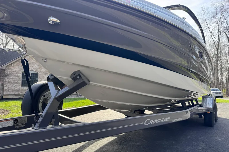 Slide: The Image of 2022 Crownline 265 SS boat on trailer, parked outdoors. - 7