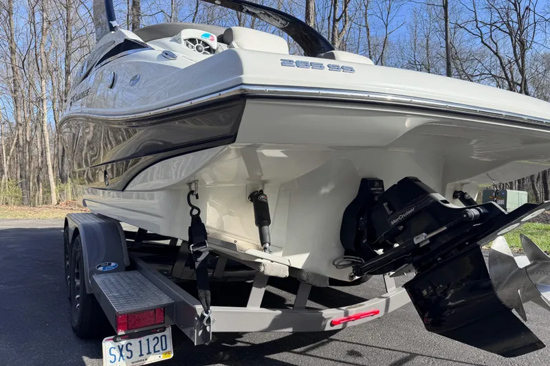 Slide: The Image of 2022 Crownline 265 SS boat on trailer, rear view, parked outdoors. - 9