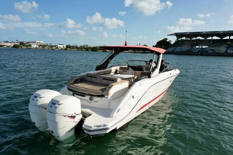 Slide: The Image of 2017 Sea Ray SLX 310 Outboard boat on water, sunny day, scenic background. - 13