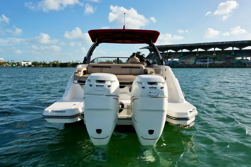 Slide: The Image of 2017 Sea Ray SLX 310 Outboard boat on water, sunny day, bridge in background. - 14