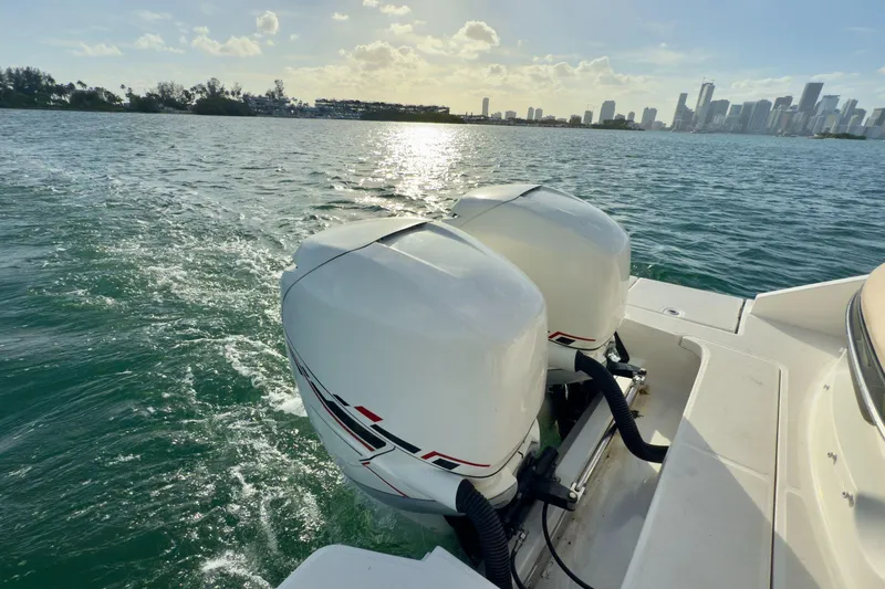 Slide: The Image of 2017 Sea Ray SLX 310 Outboard cruising on sunny waters near city skyline. - 15
