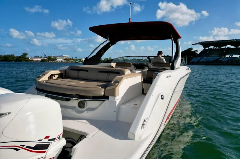 Slide: The Image of 2017 Sea Ray SLX 310 Outboard cruising on a sunny day with clear blue skies. - 16
