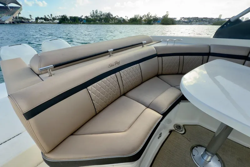 Slide: The Image of Luxurious seating on a 2017 Sea Ray SLX 310 Outboard boat by the water. - 21
