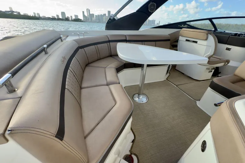 Slide: The Image of Luxurious interior of 2017 Sea Ray SLX 310 Outboard with plush seating and table. - 22