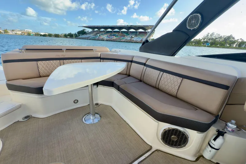Slide: The Image of Luxurious seating area on a 2017 Sea Ray SLX 310 Outboard boat with waterfront view. - 23