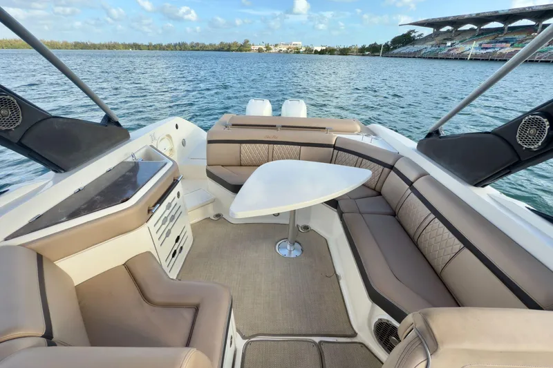 Slide: The Image of Luxurious 2017 Sea Ray SLX 310 Outboard boat interior with elegant seating and table. - 24